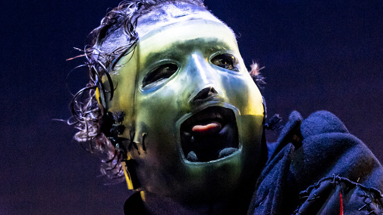 Masked Corey Taylor pulling a tongue on stage