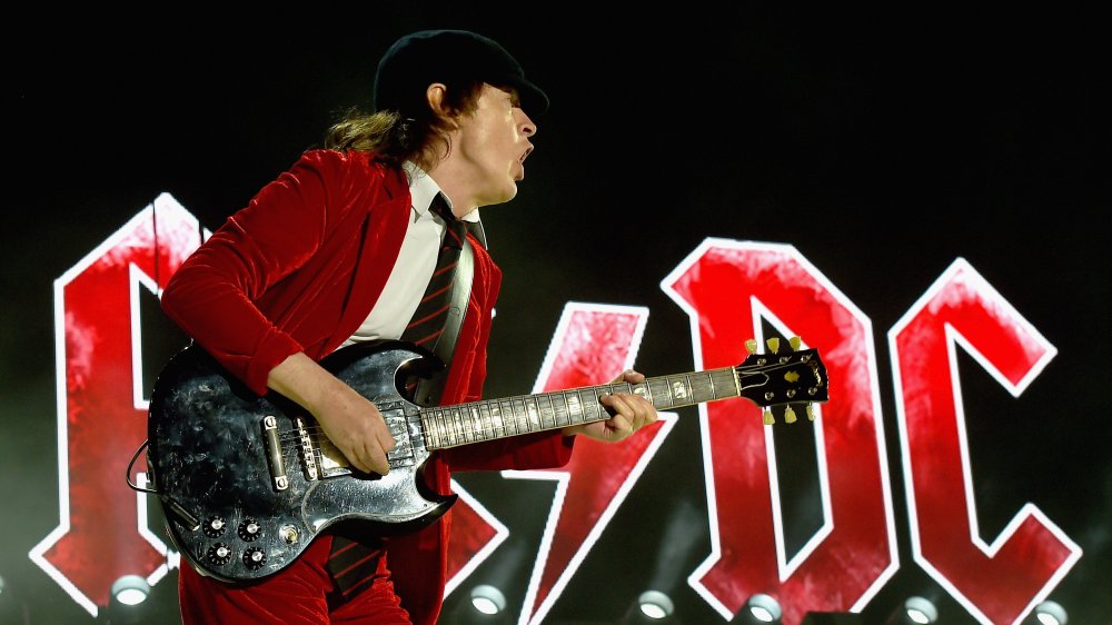 The Real Reason Angus Young Started Wearing Schoolboy Uniforms On Stage