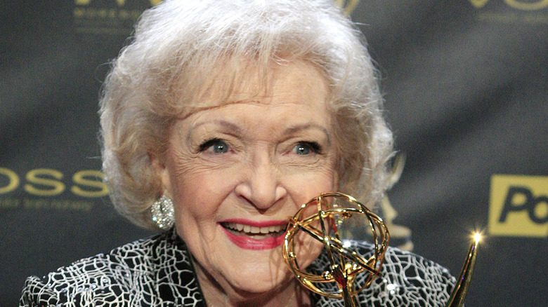 Betty White holding award