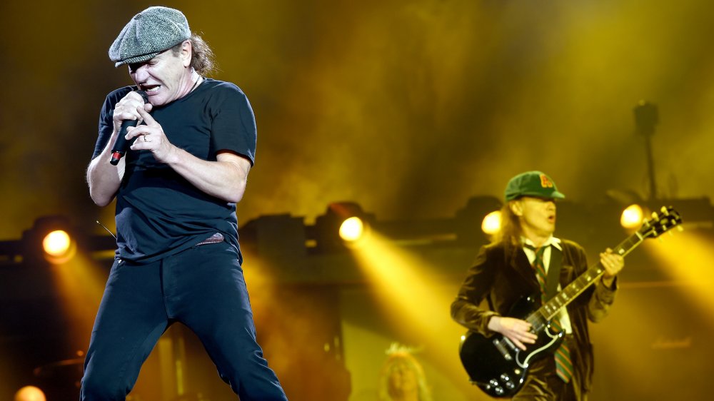 Brian Johnson singing with Angus Young playing the guitar in the background