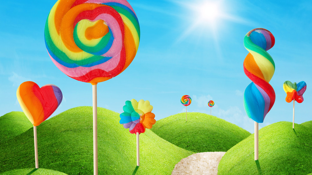 Cartoon lollipops amid rolling hills