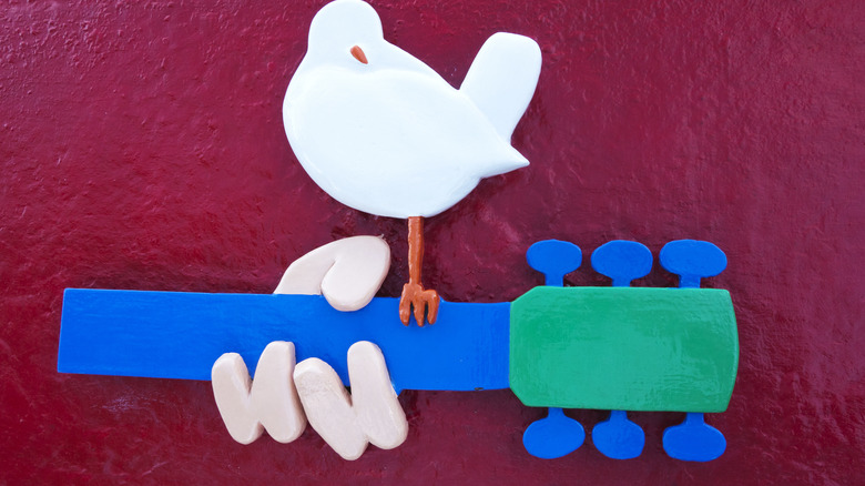 Woodstock dove and guitar symbol