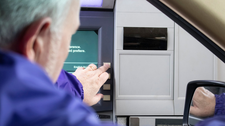 Man using drive-up ATM