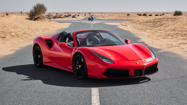 a ferrari on the road in a desert