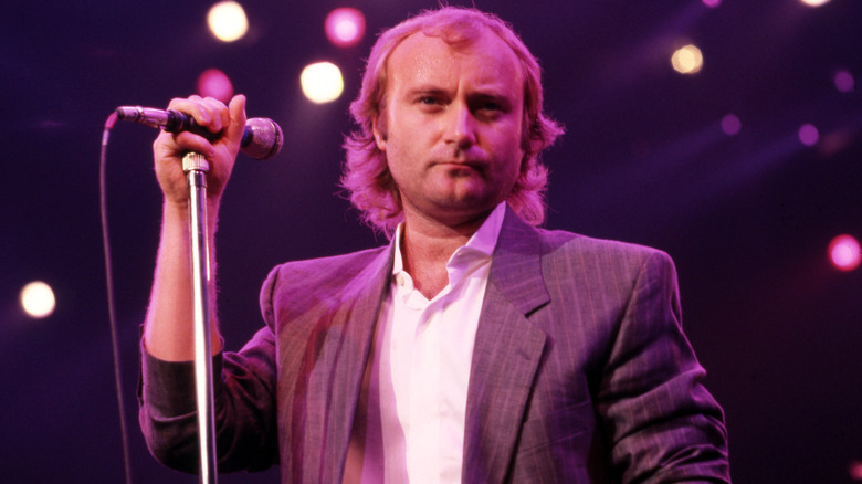 Phil Collins holding microphone