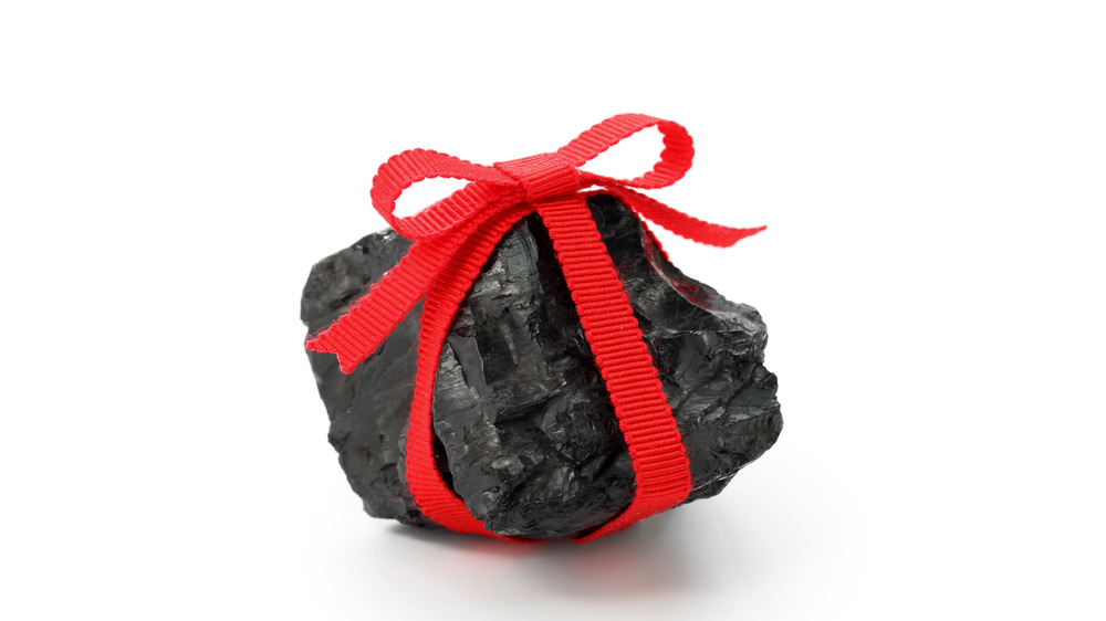 A lump of coal with a red ribbon around it