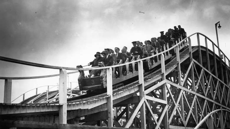 people riding roller coaster