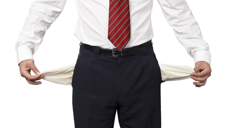Guy pulling out empty pockets