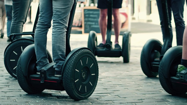 legs of people on Segways