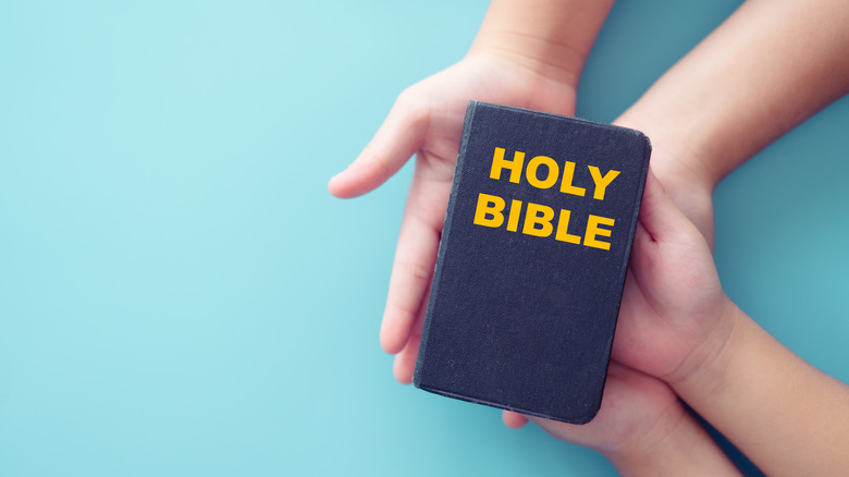 Holy Bible and hands