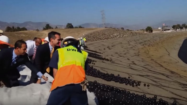 dumping shade balls into water