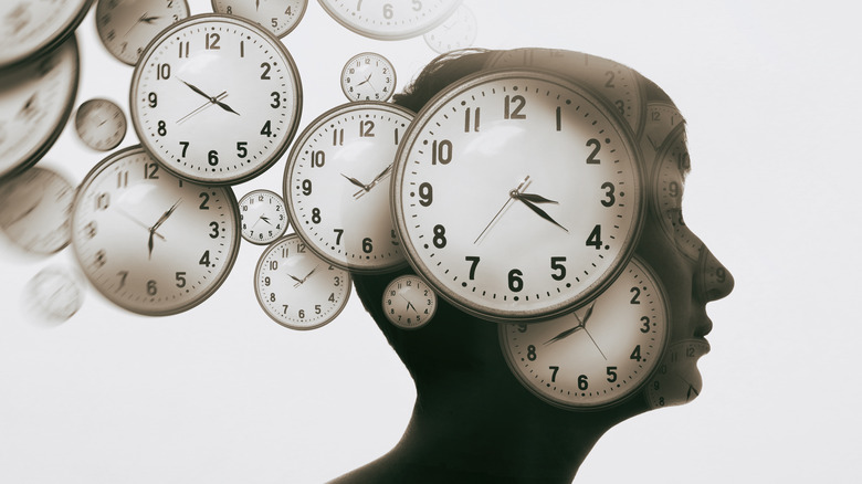 Clocks emerging from woman's head, stock image