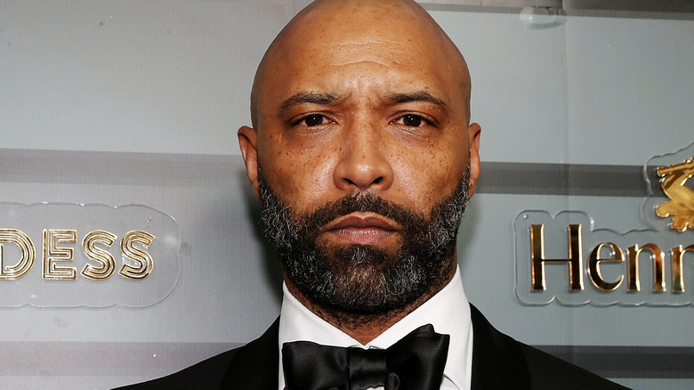 Joe Budden scowling tuxedo