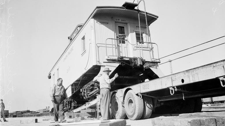 caboose is loaded onto tracks
