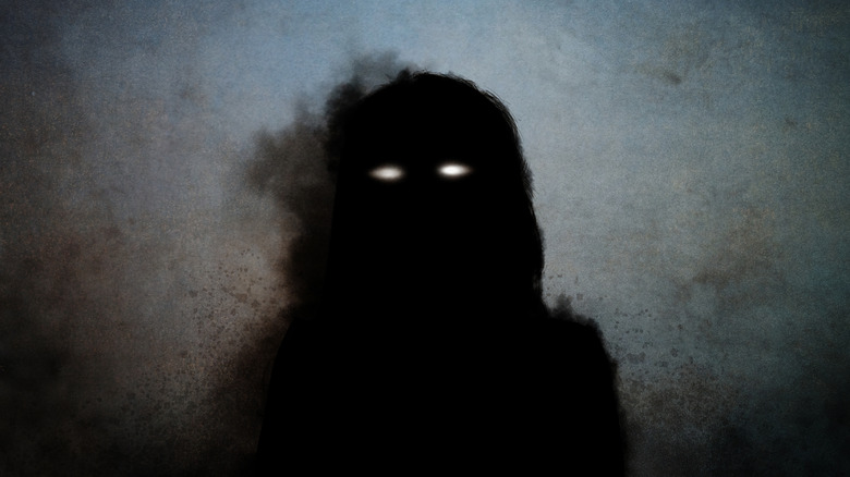 demonic silhouette with glowing eyes