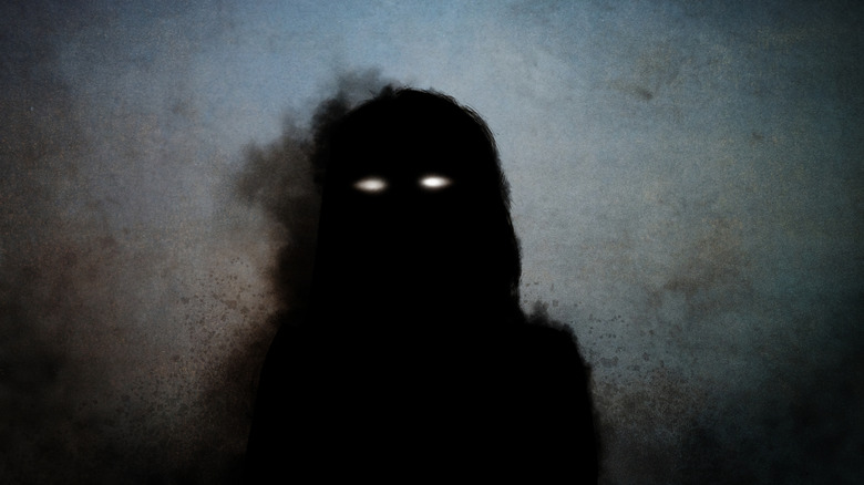demonic silhouette with glowing eyes