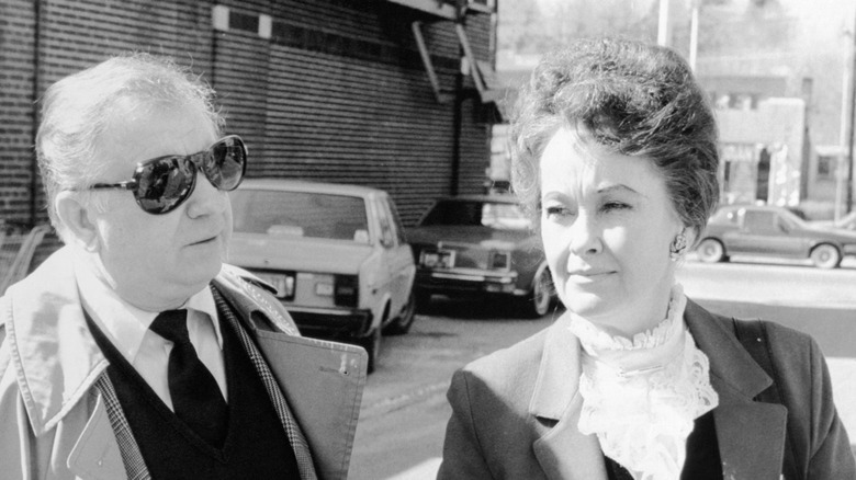 Ed and Lorraine Warren in smart dress outdoors by street