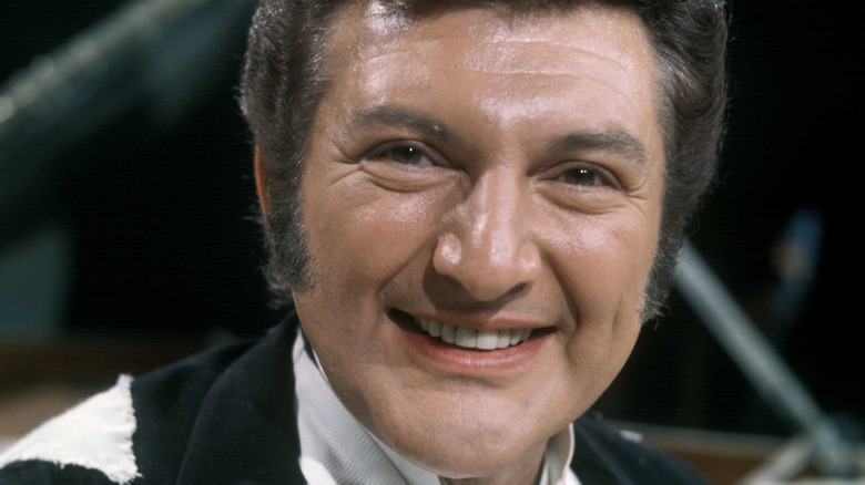 Liberace smiling broadly