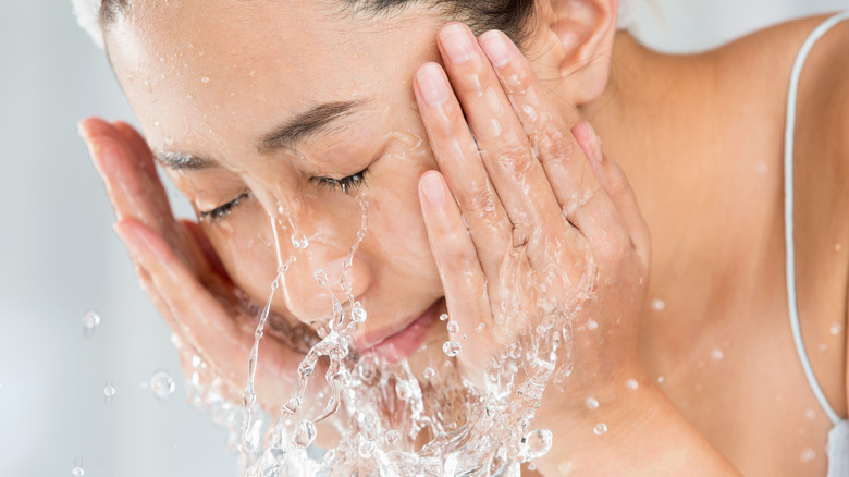 woman splashing face