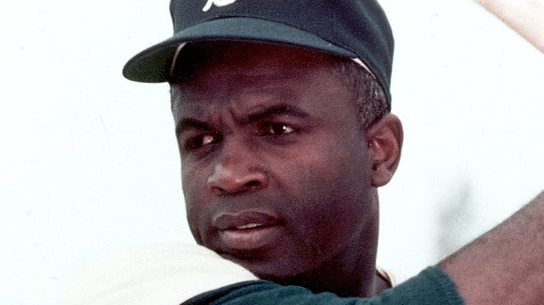 Jackie Robinson swinging a baseball bat