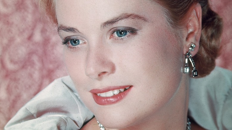 grace kelly smiling pink background