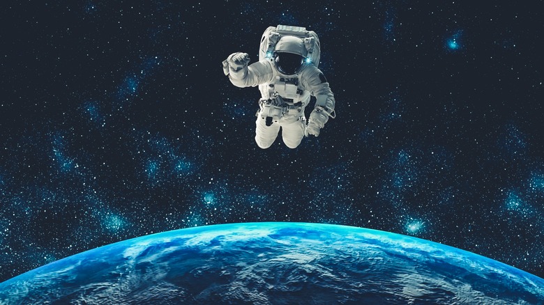 Astronaut floating above planet