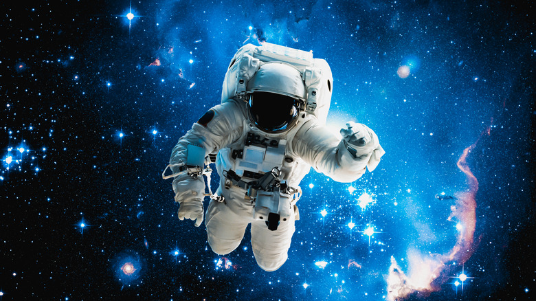 Astronaut floating against space backdrop