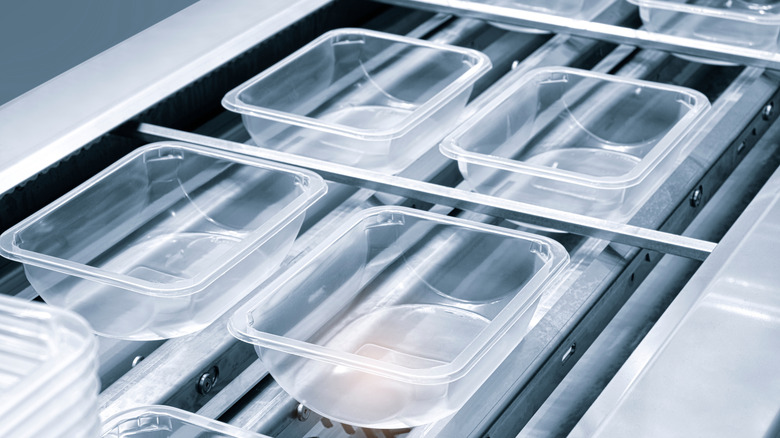 Plastic containers on factory conveyor belt