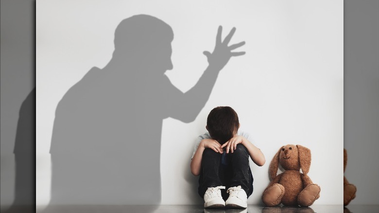 shadow of father yelling at boy