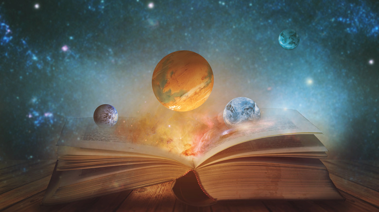 planets floating above an open book