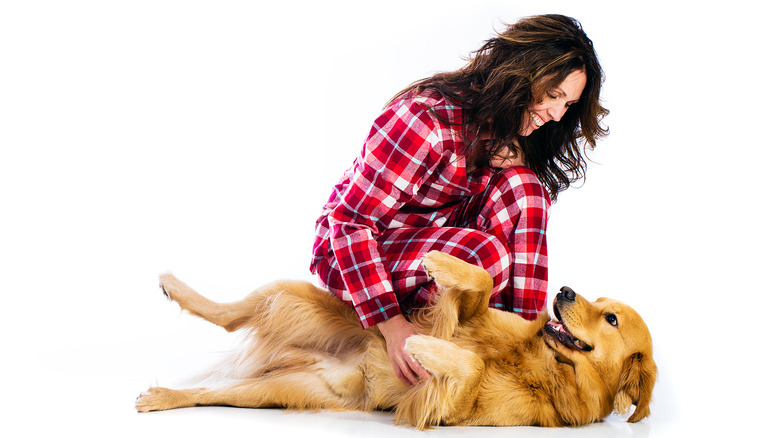 woman scratching dog