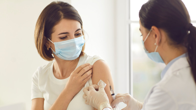 Doctor vaccinating woman patient