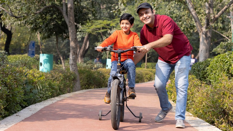 Child being taught to ride bike