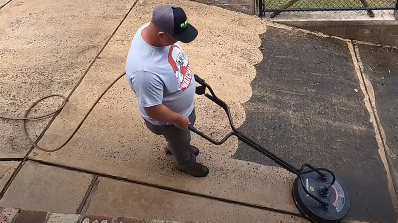  pressure washing a dirty driveway
