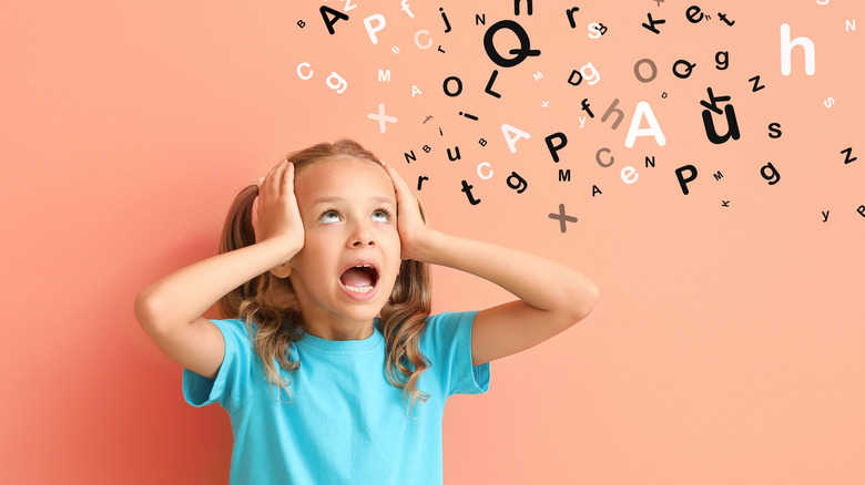 girl looks confused by letters.