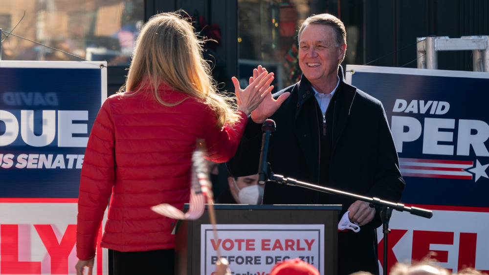 David Perdue giving a high five 