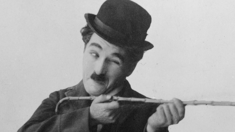 Charlie Chaplin brandishing cane