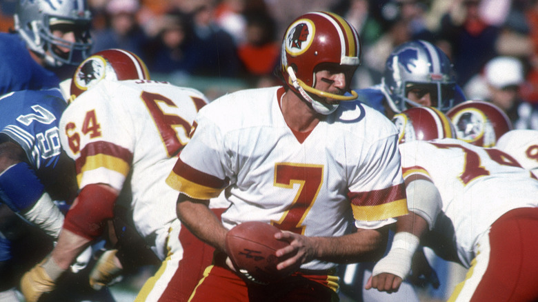 Joe Theismann prepares to hand off to RB