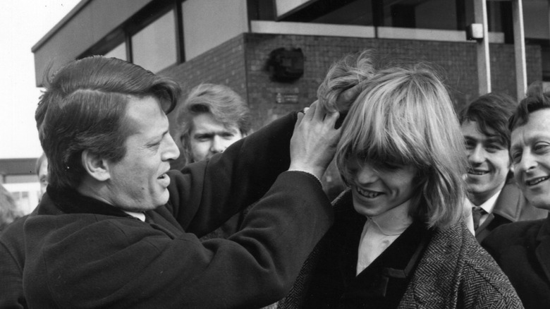 David Bowie getting hair mussed