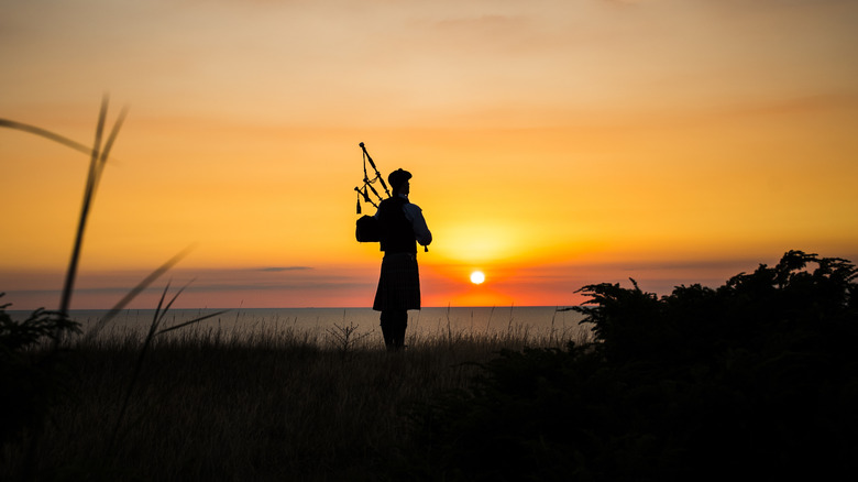 Bagpiper silhouette with sunset
