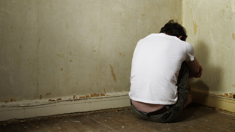 man sitting in corner