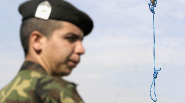 The noose that hanged Mohammad Bijeh is guarded by a soldier