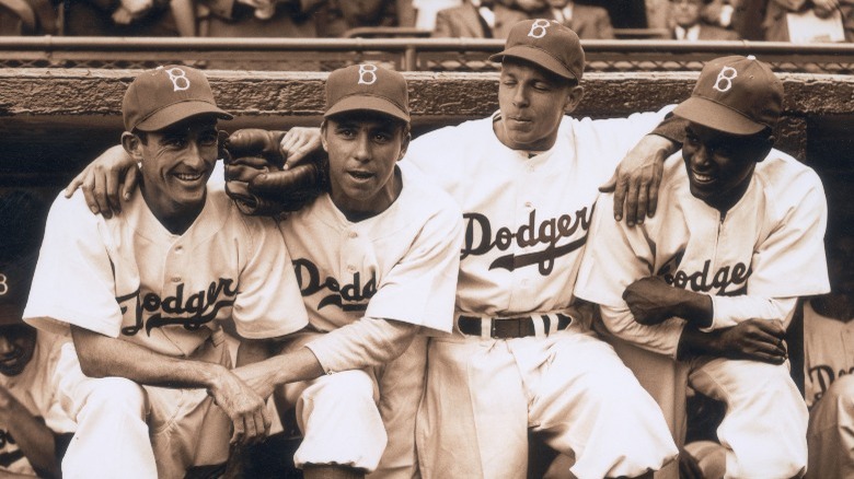 Robinson and teammates sitting together on stadium bench
