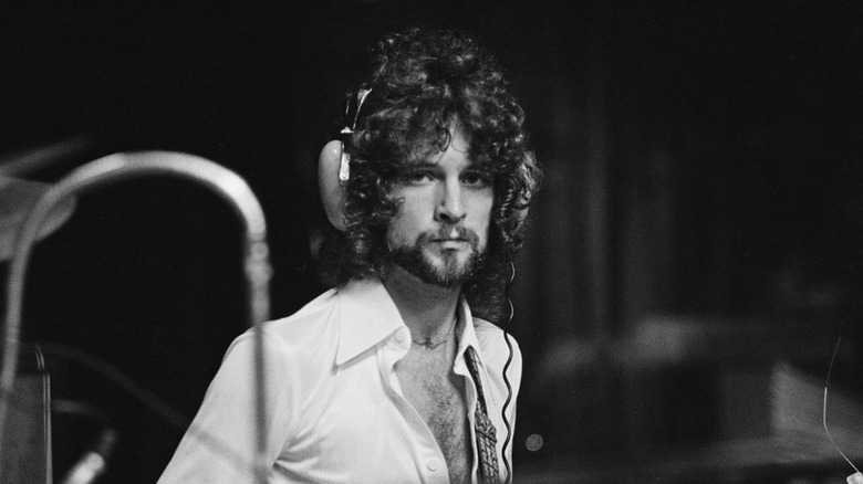 Lindsey Buckingham in recording studio wearing headphones
