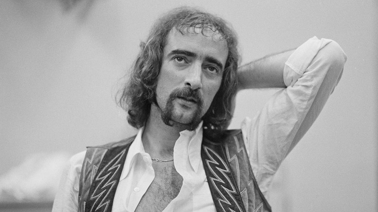 John McVie with hand behind head looking up