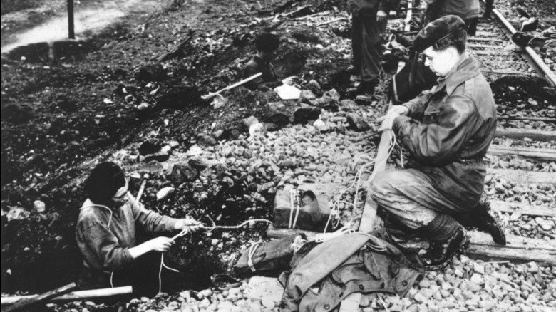 U.S. commandos rigging railroad with demolition