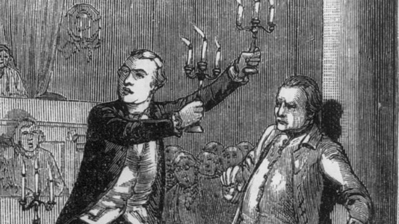 Burr holding candles up to Croucher
