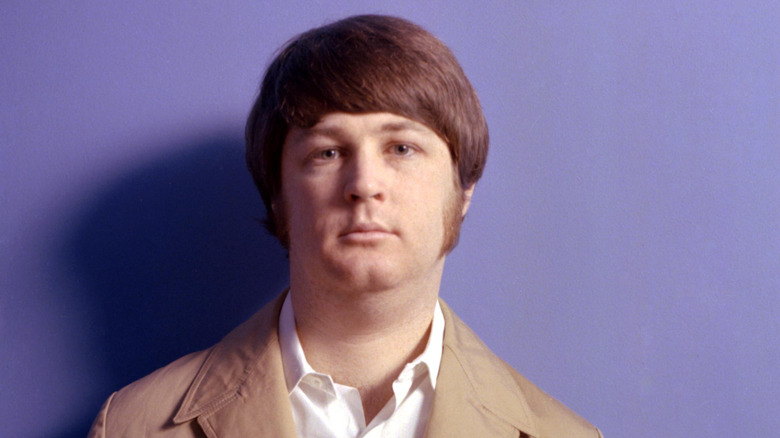 Portrait of Brian Wilson in front of a purple background