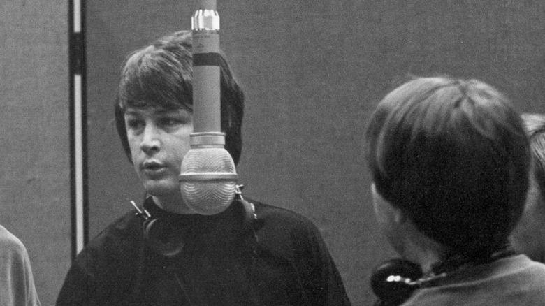Brian Wilson near a microphone in the recording studio
