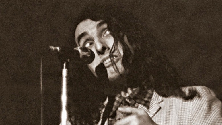 Tiny Tim performing weird face